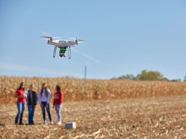 Drone flying in a field