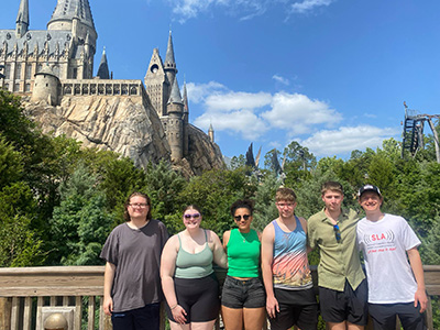group of students with castle in background